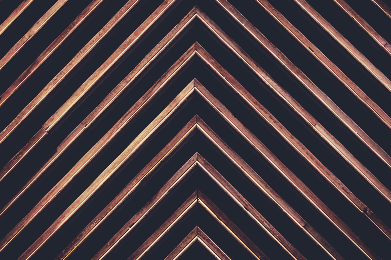 Dark chevron-patterned wood wall detail